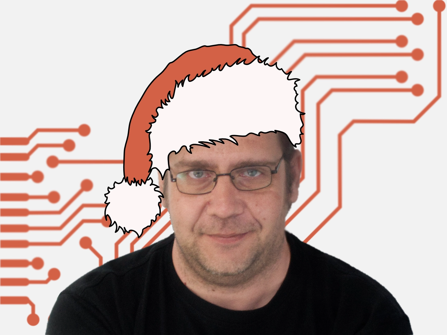 Mann mit Brille und langen Haaren, lächelnd in schwarzem T-Shirt